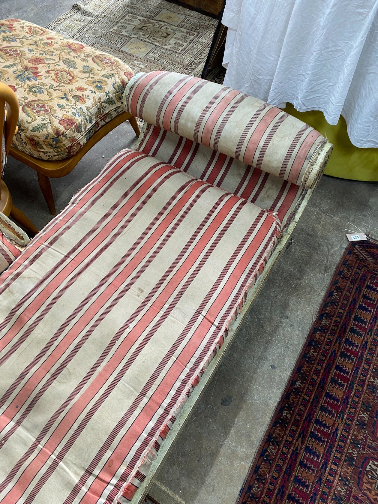 A Regency painted parcel gilt scroll end chaise longue, length 196cm, width 65cm, height 70cm